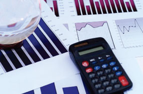 Calculator on top of papers with graphs